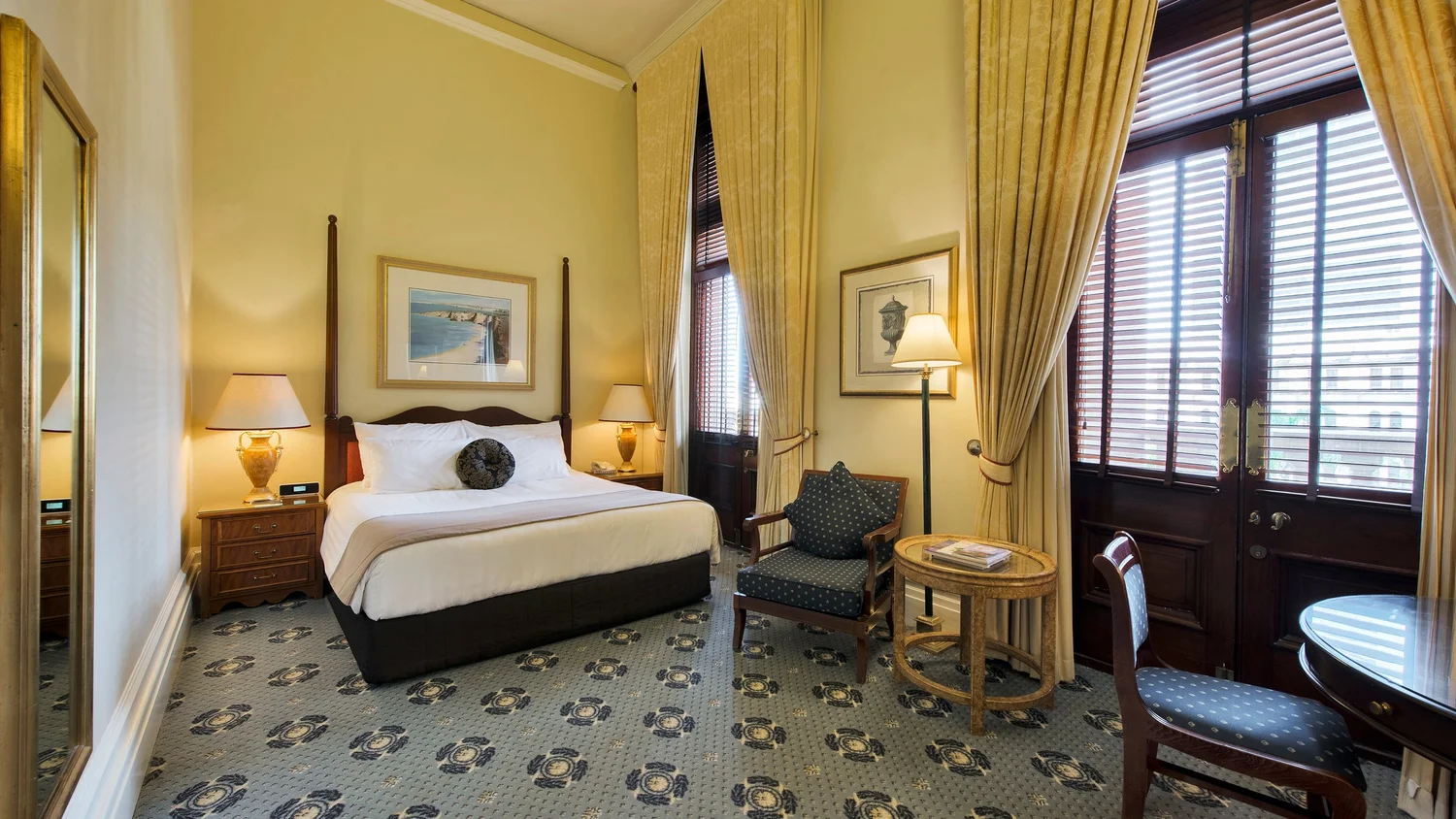 Deluxe King Room at Treasury Brisbane with heritage details and king bed
